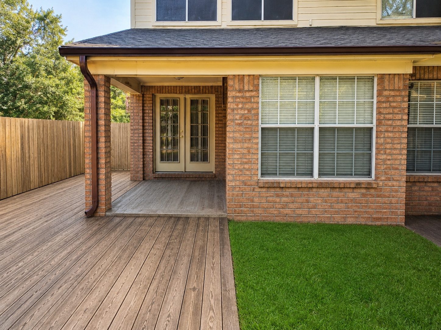 Dark bronze gutter on a covered deck, matched to the trim.