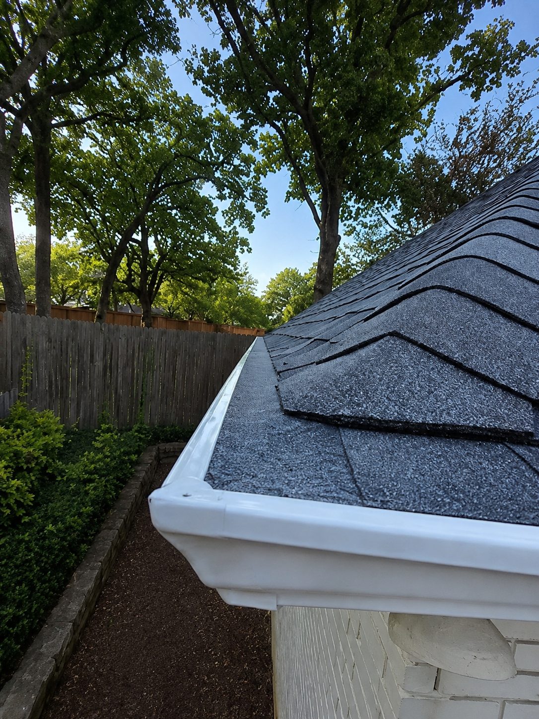 Mitered, riveted and sealed corner on a new white seamless gutter.